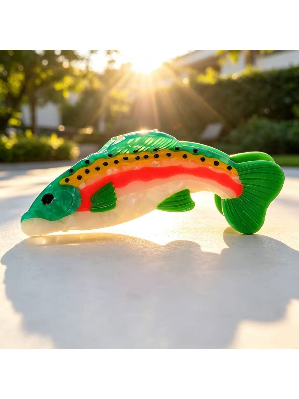 Beau fish shape claw clip placed on wooden surface with natural light