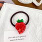 Hair ties with various fruit charms arranged in a circle
