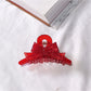 Beau acetate bow shaped claw clip displayed with hair styled using clip