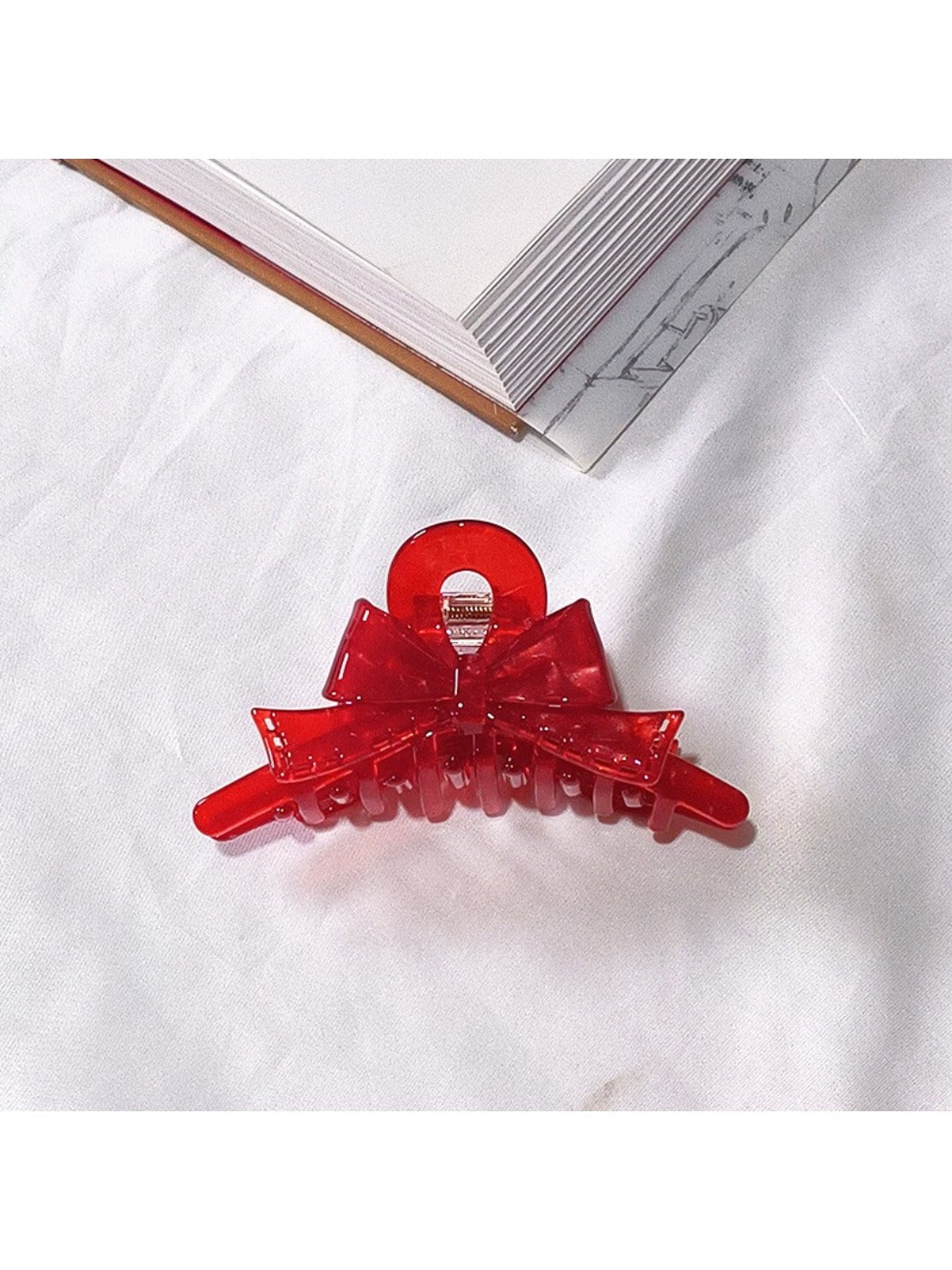Beau acetate bow shaped claw clip displayed with hair styled using clip