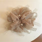 Close-up of Gifty elegant scrunchie with a large bow accent in soft fabric