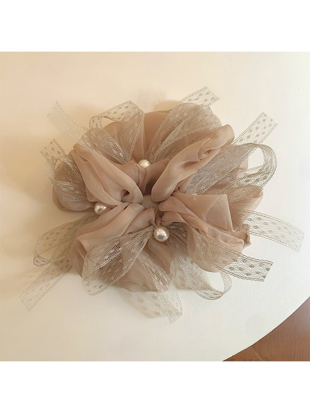 Close-up of Gifty elegant scrunchie with a large bow accent in soft fabric