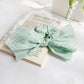 Side view of striped bow scrunchie highlighting bow shape and stripes