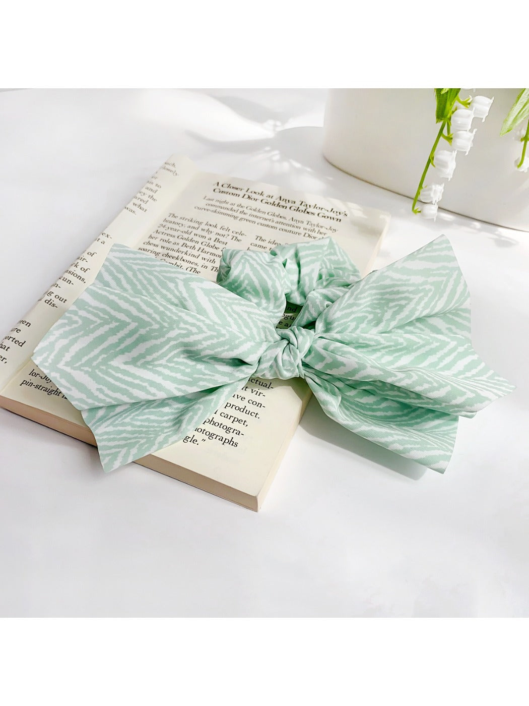 Side view of striped bow scrunchie highlighting bow shape and stripes