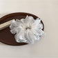 Gifty scrunchie stretched to show elastic band inside