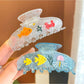 Beau cute little fish decor claw clip shown closed on a white background