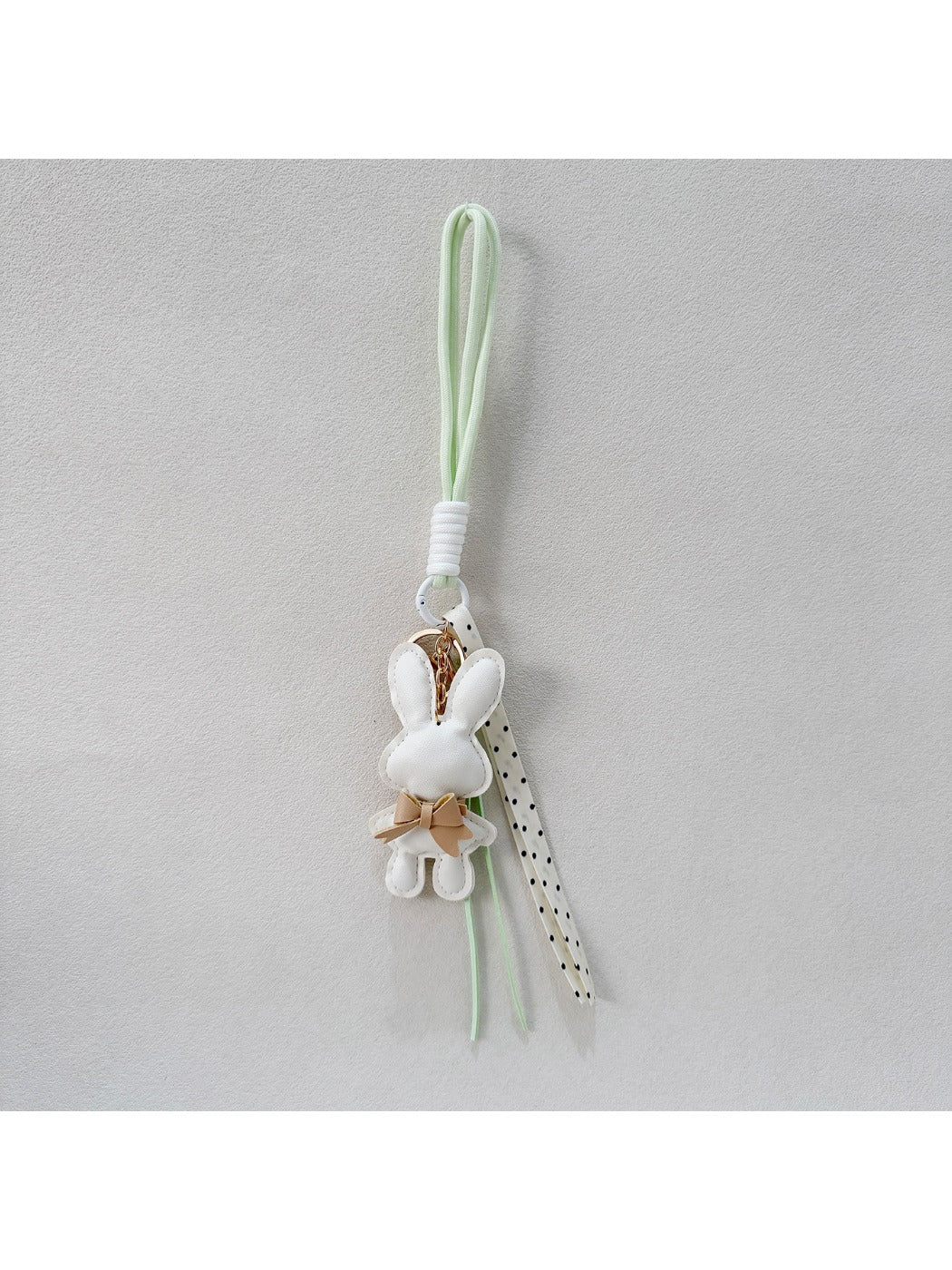 Close-up of metal keyring connected to bunny shaped keychain
