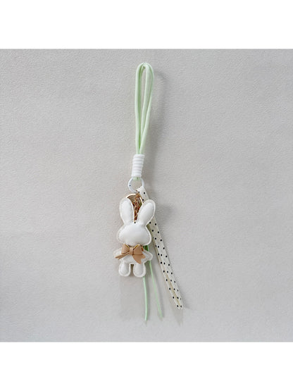 Close-up of metal keyring connected to bunny shaped keychain