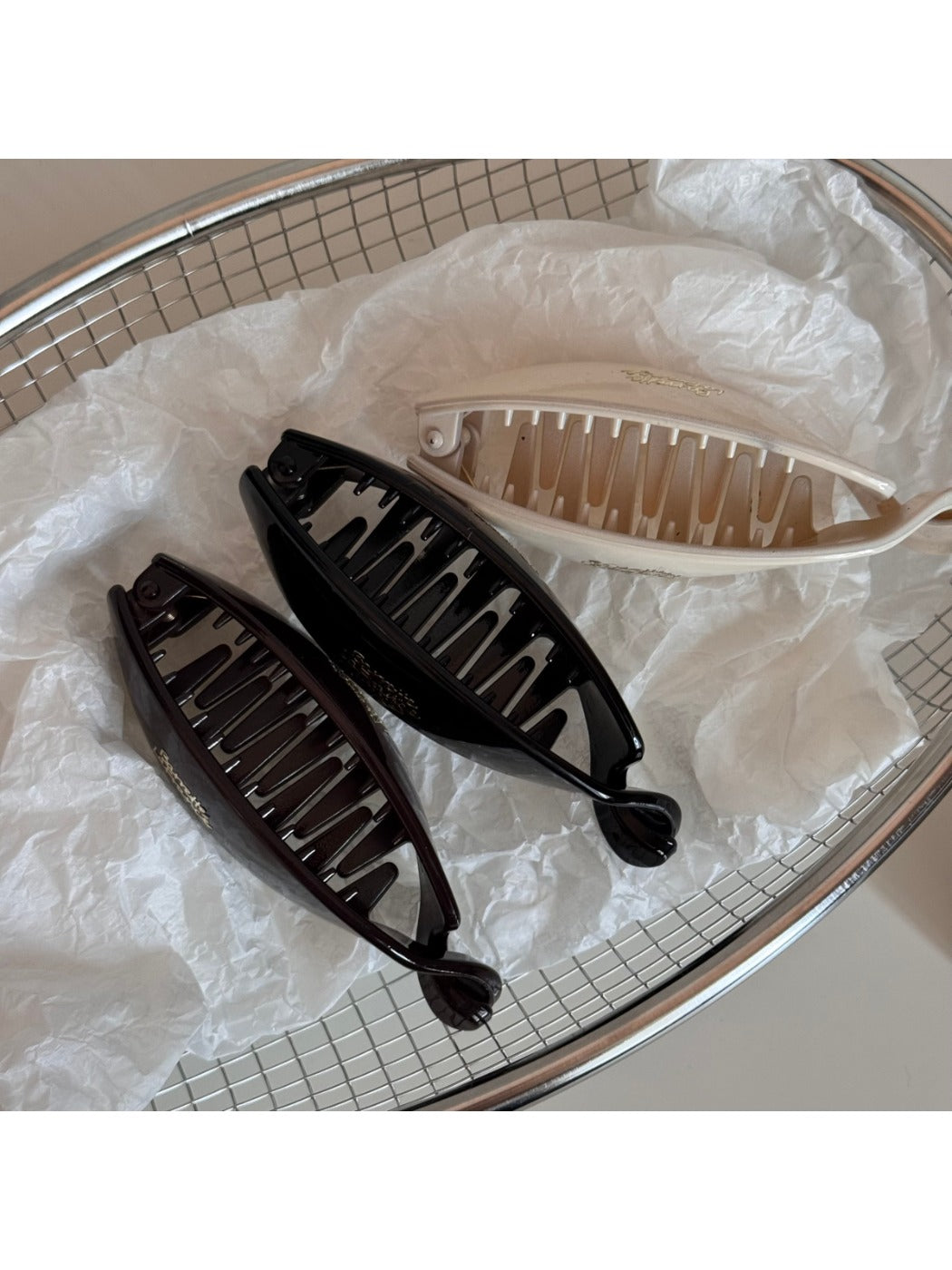 Beau minimalist stick hair clip securing a bun hairstyle on model