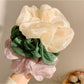 Close-up of Gifty gentle simple elegant scrunchie in soft pastel fabric