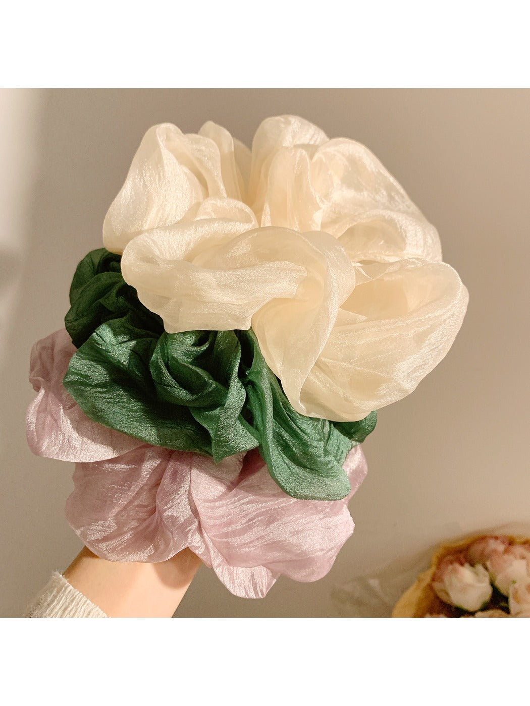 Close-up of Gifty gentle simple elegant scrunchie in soft pastel fabric