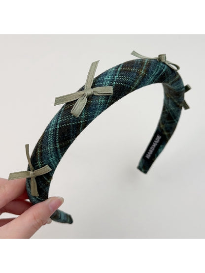 Gifty plaid bow headband placed next to matching plaid accessories