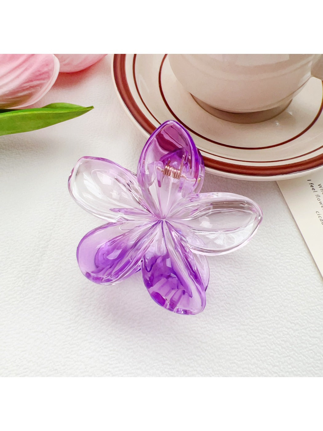 Beau colorful flower claw clip attached to hair demonstrating usage and hold