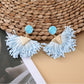 Earedge raffia earrings displayed with matching necklace on neutral background