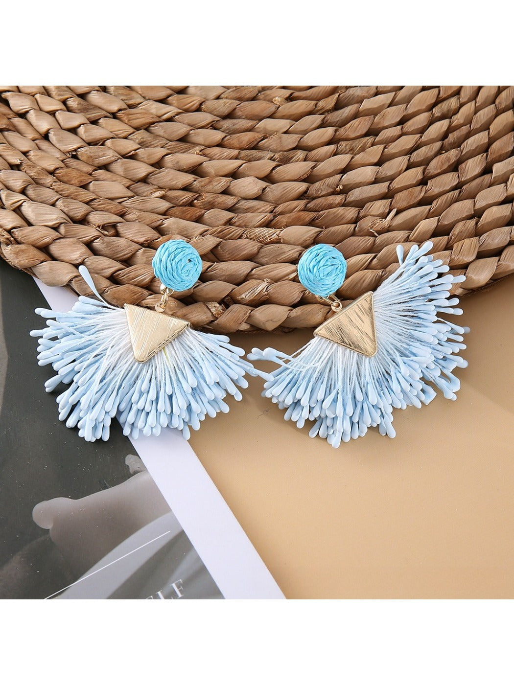 Earedge raffia earrings displayed with matching necklace on neutral background