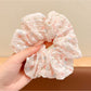Gifty scrunchie in soft pastel colors with delicate floral design