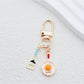 Spatula shaped keychain with wooden handle and metal blade detail