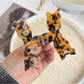 Side view of Beau bow shaped hair claw clip highlighting curved teeth