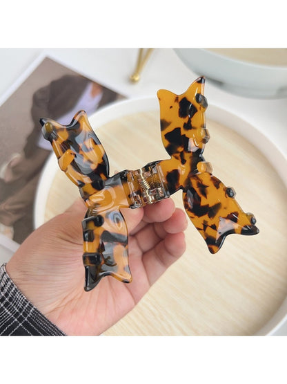 Side view of Beau bow shaped hair claw clip highlighting curved teeth