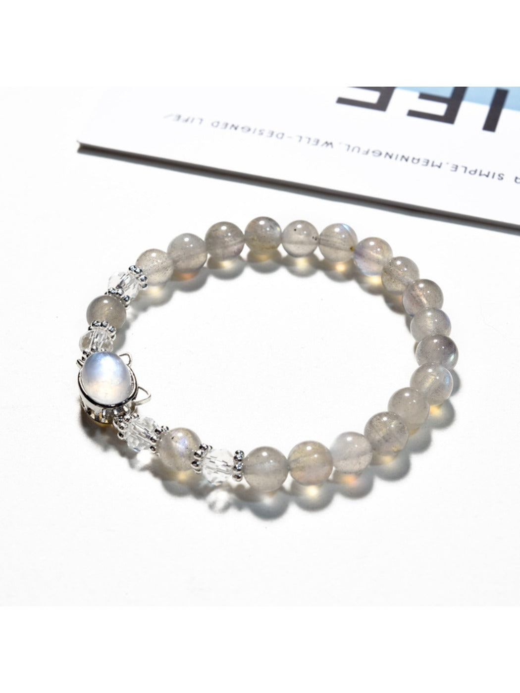 Lovra gray crystal beaded bracelet displayed on a wooden surface