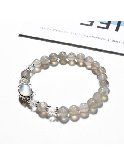 Lovra gray crystal beaded bracelet displayed on a wooden surface