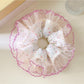 Polka dot ruffle scrunchie styled on a wrist as an accessory