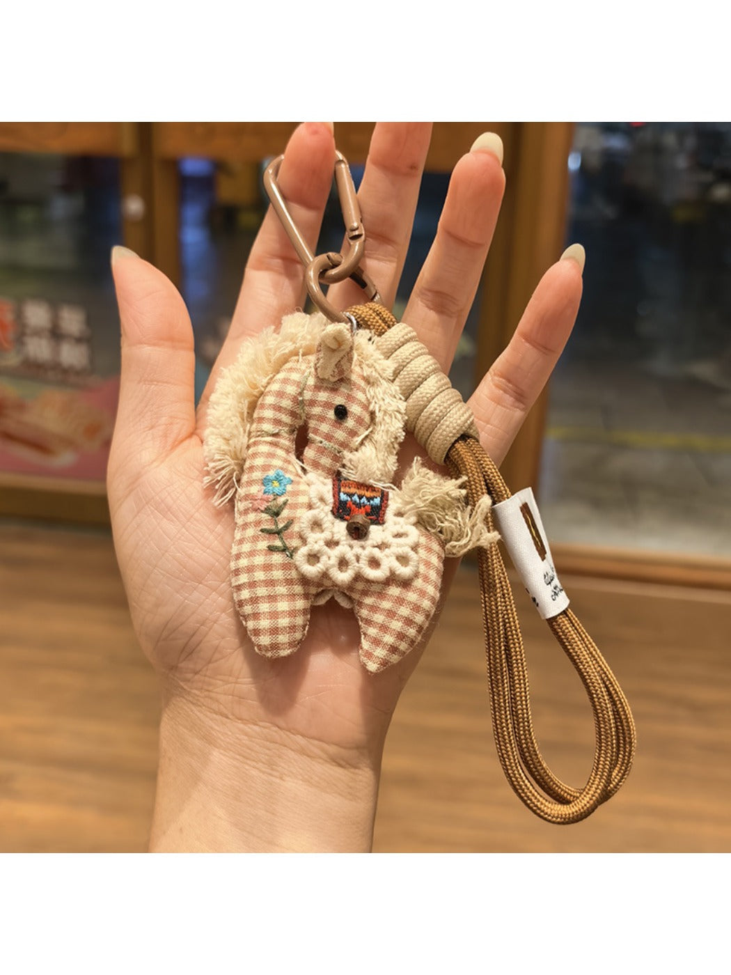 Fabric pony keychain with pastel colors and soft texture close-up
