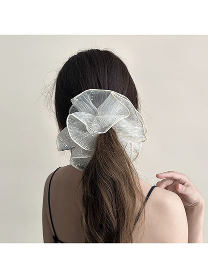 Gifty scrunchie styled on a wrist, highlighting its double layer ruched design