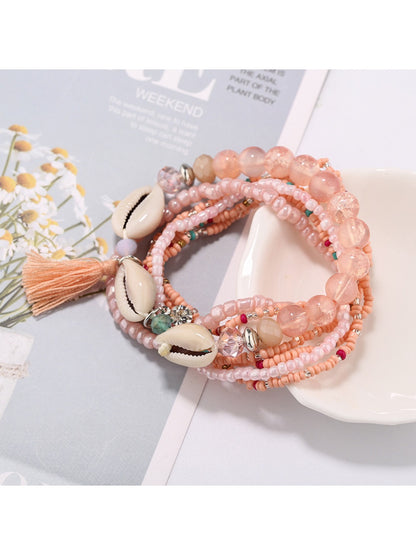 Multiple Lovra beaded bracelets stacked together showcasing bohemian style