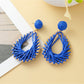 Earedge hollow drop woven earrings packaged in branded jewelry box