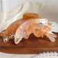 Butterfly shaped hair claw clip displayed with natural lighting