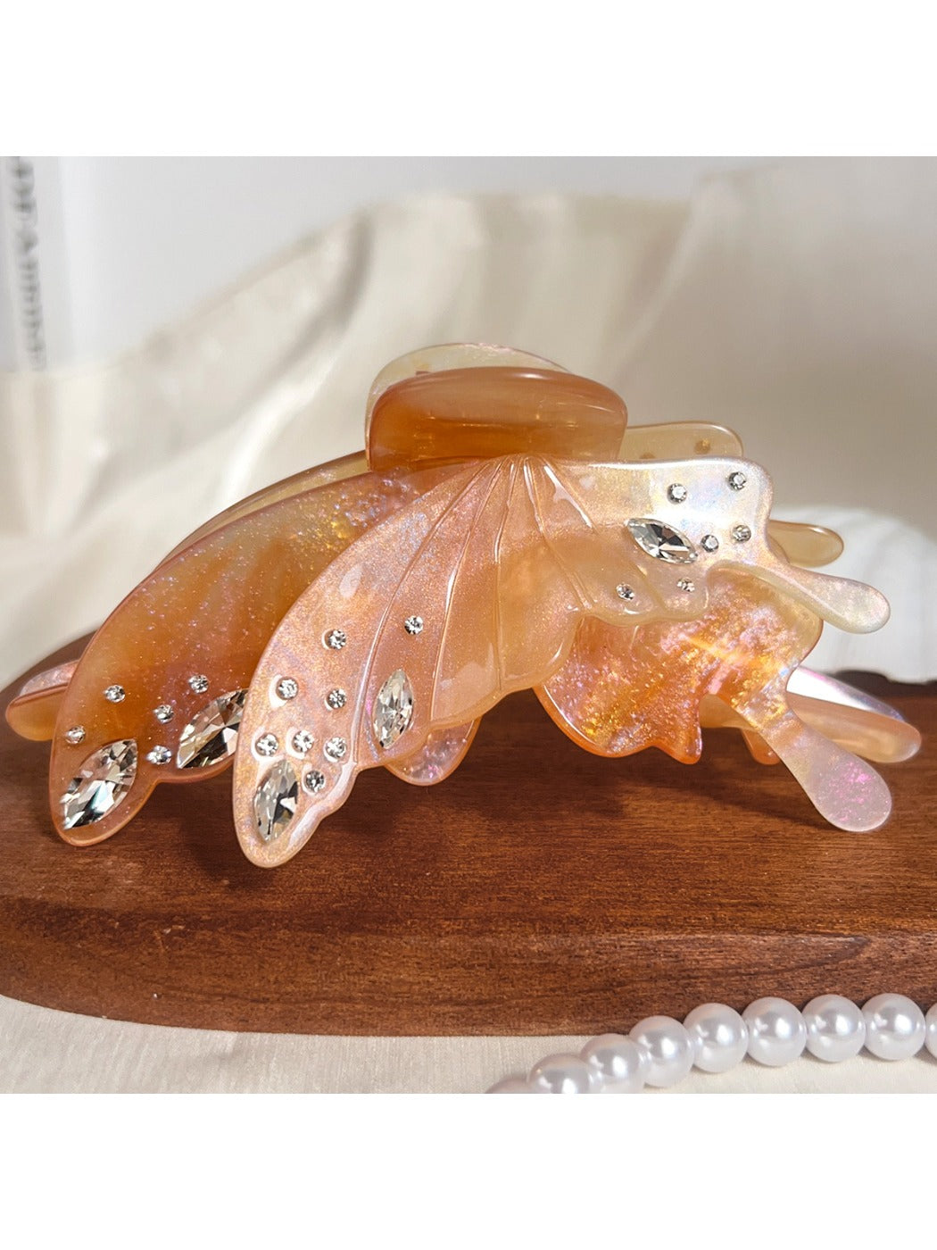 Butterfly shaped hair claw clip displayed with natural lighting