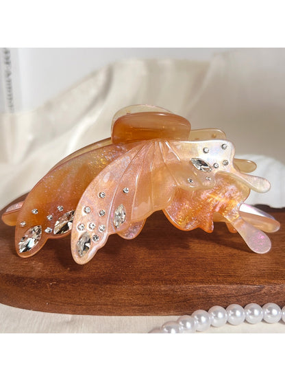 Butterfly shaped hair claw clip displayed with natural lighting
