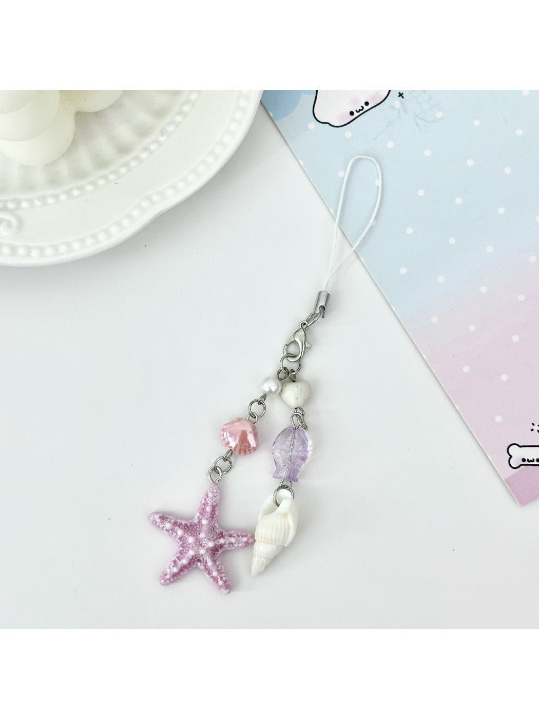 Mini starfish keychain displayed with other beach-themed accessories