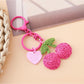 Keypus cherry charm keychain packaged in a clear plastic bag with branding