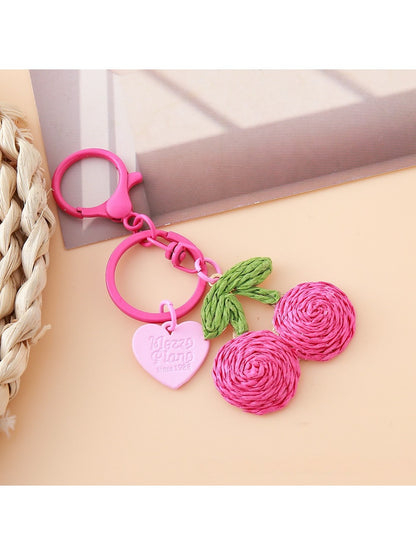 Keypus cherry charm keychain packaged in a clear plastic bag with branding