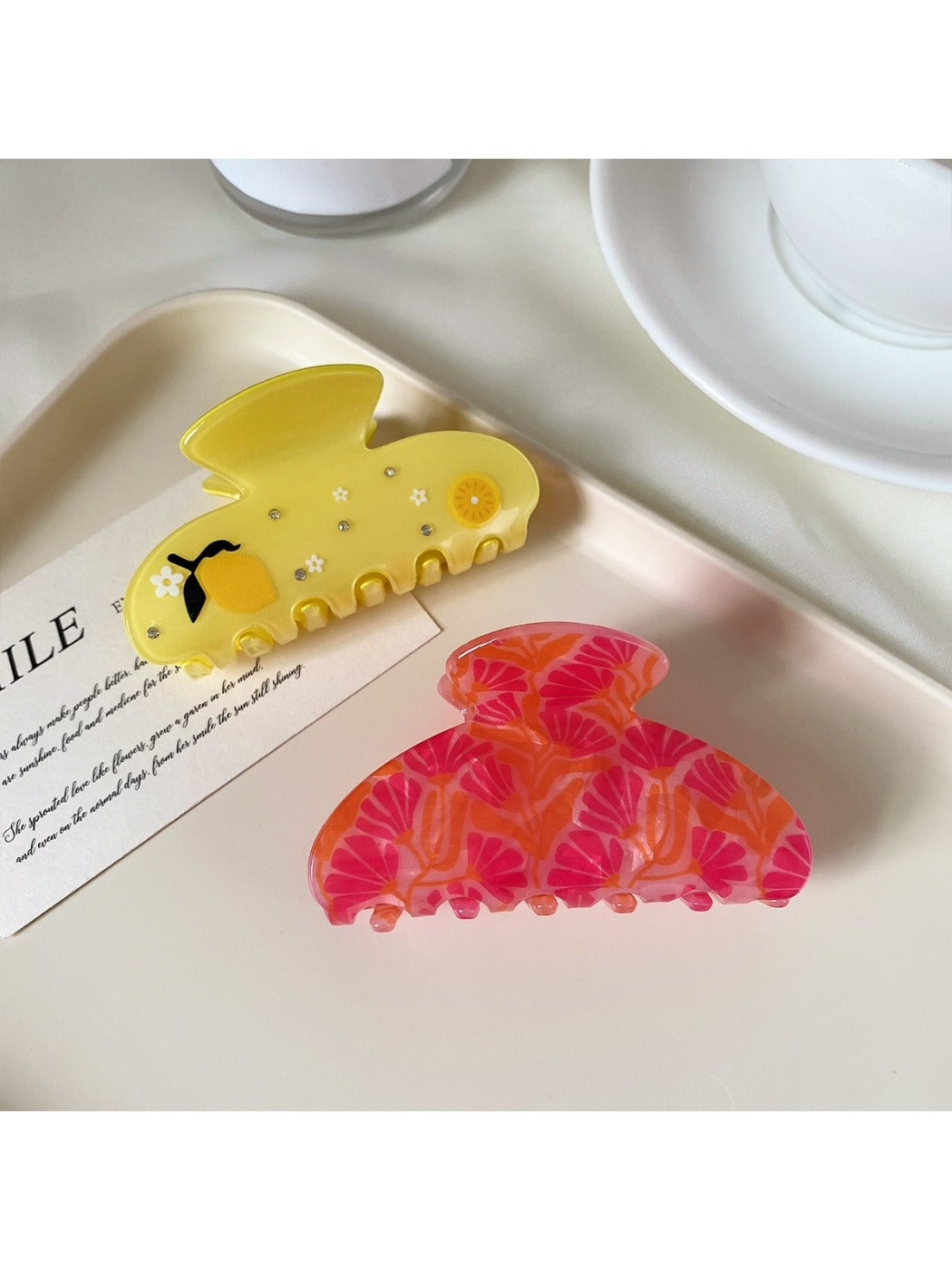 Beau hair claw clip held in hand displaying size and curved half round shape