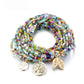 Lovra bracelet with leaf pendant resting on wooden surface highlighting design details