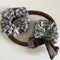 Close-up of Gifty vintage plaid bow scrunchie in red and beige tones