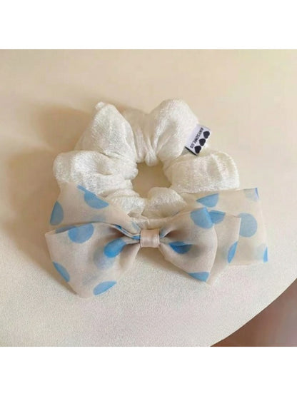 Gifty hair tie styled in a ponytail with polka dot bow visible