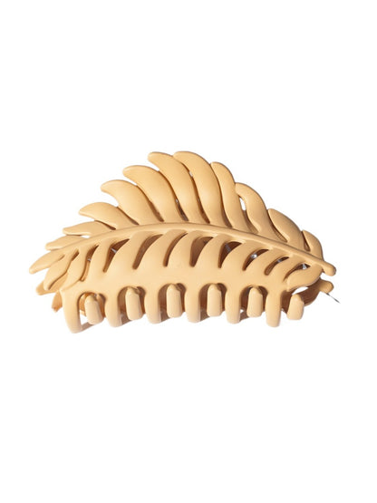 Beau hair clip placed on natural wooden surface