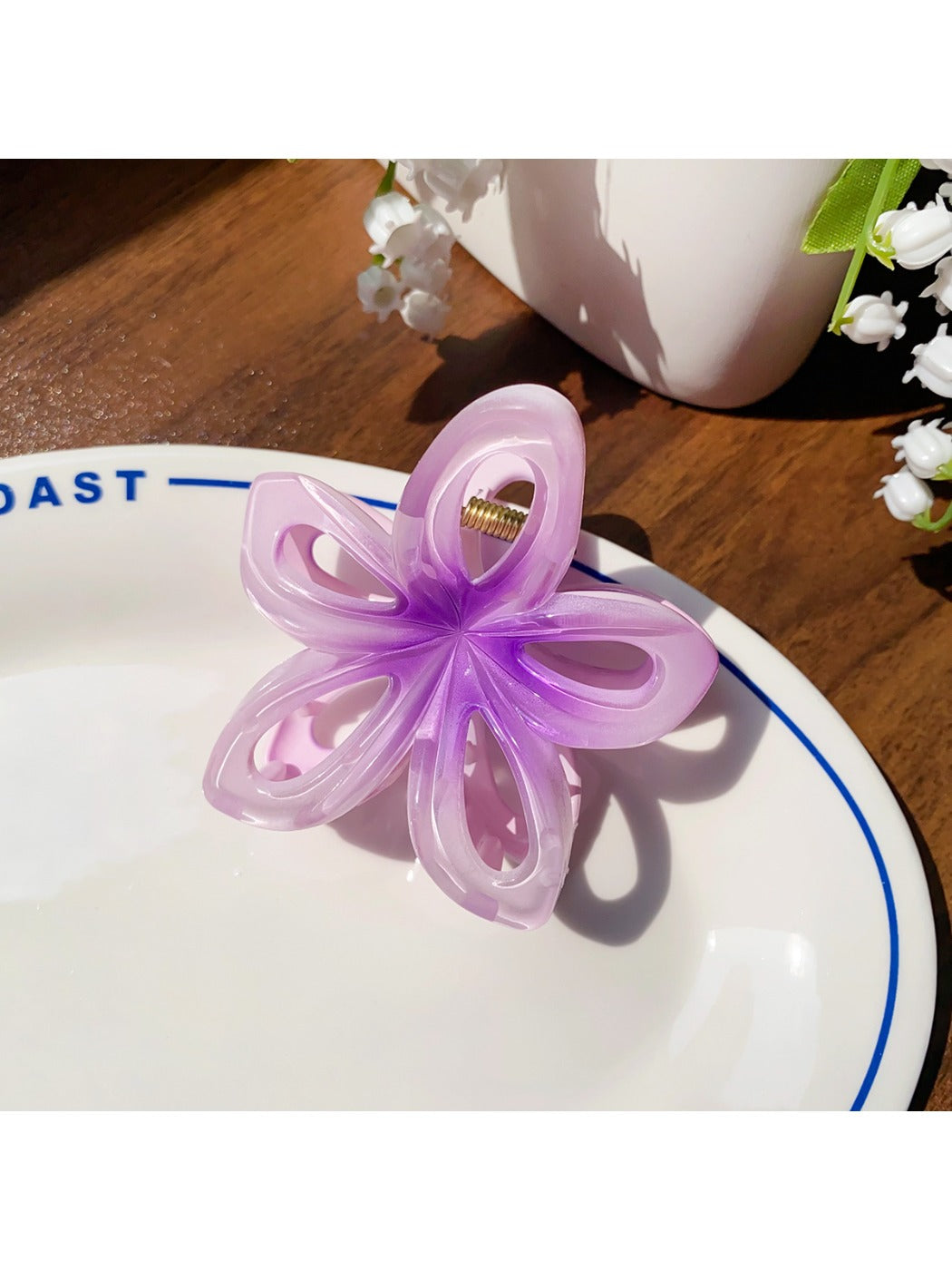 Beau flower hair claw clip clipped into thick hair from the back