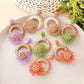 Close-up of Earedge raffia daisy shaped stud earrings on white background