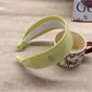 Gifty wide headband in solid color styled with hair pulled back
