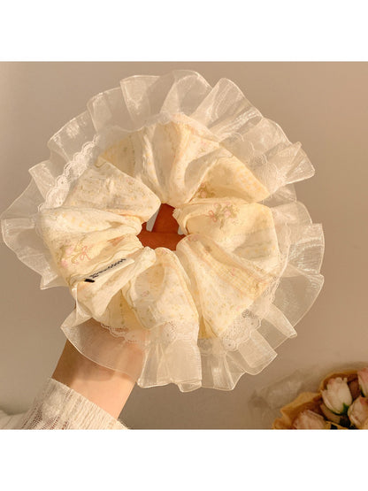 Gifty Ditsy Floral Lace Trim Scrunchie styled in hair with visible floral print and lace trim