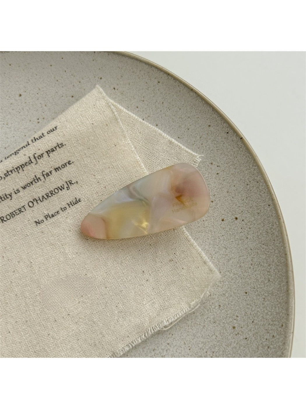 Beau hair clip resting on a wooden surface with natural light