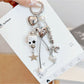 Keypus cute star and bow charm keychain with gold ring on white background
