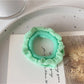 Flat lay of assorted colorful ruffled hair ties with a gift box