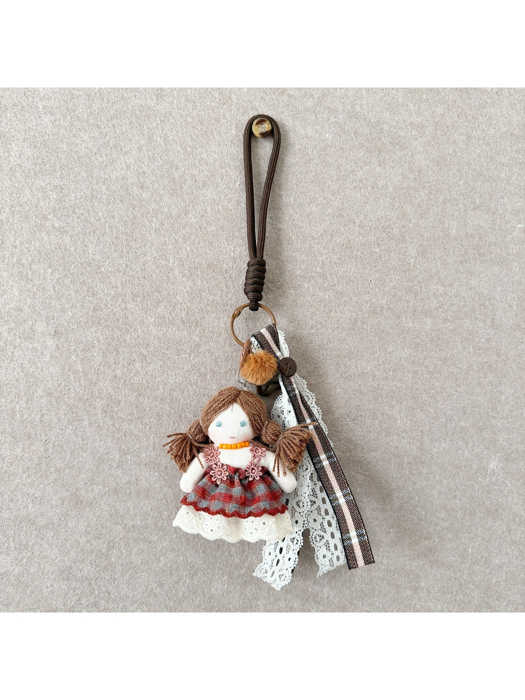 Keypus doll keychain attached to a bag zipper pull