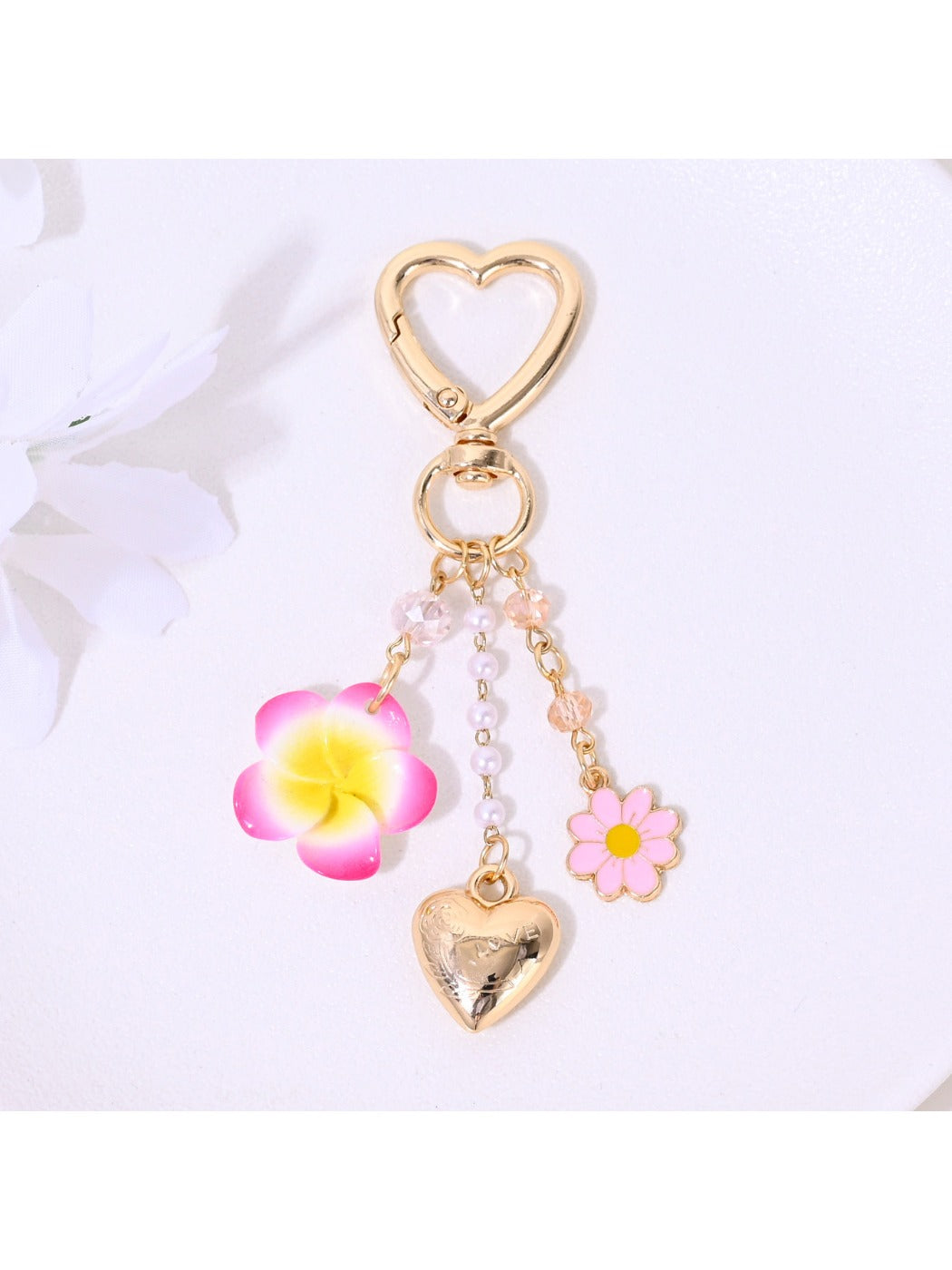 Close-up of red heart flower keychain attached to a bag zipper